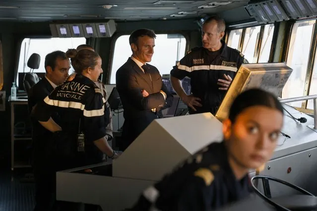 French Navy Captain and commander of the Charles de Gaulle Sebastien Martinot (R) speaks with French Armies Minister Sebastien Lecornu (L) and French President Emmanuel Macron (C) on the navigation pont aboard the French aircraft carrier Charles de Gaulle, sailing between the Suez canal and the Red Sea on December 19, 2022. French President Emmanuel Macron joined the French aircraft carrier Charles de Gaulle on December 19, 2022 for the traditional Christmas party with the troops, before attending a regional conference in Jordan on December 20, the Elysee presidential palace announced. (Photo by Ludovic Marin/Pool via AFP Photo)