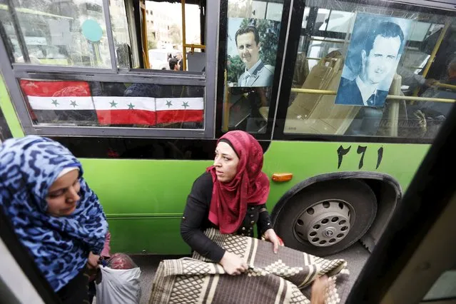 Women carry belongings they collected from their damaged houses as they get into into a bus after their visit to the city of Palmyra, Syria April 9, 2016. (Photo by Omar Sanadiki/Reuters)