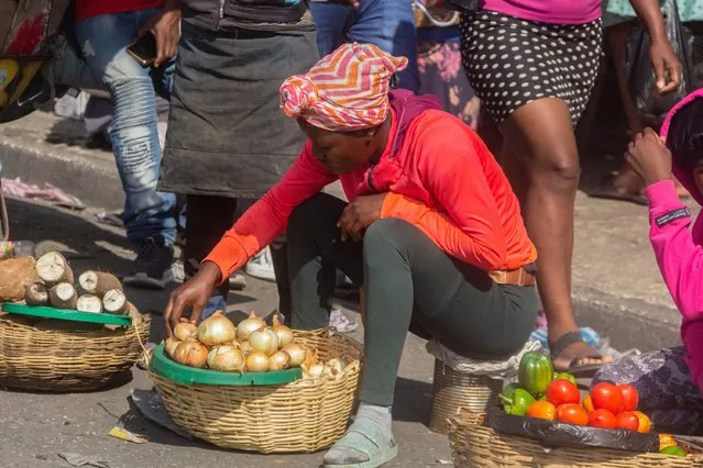 A merchant sits with a basket of onions to sell in the petion-ville market in the street amid the ongoing insecurity and political instability in Port-au-Prince, Haiti, March 21, 2024. (Photo by Guerinault Louis/Anadolu via Getty Images)