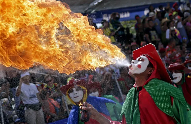 A performer breaths fire during the Great Traditional Parade at the Barranquilla's Carnival, in Barranquilla, Colombia, 26 February 2017. (Photo by Ricardo Maldonado Rozo/EPA)