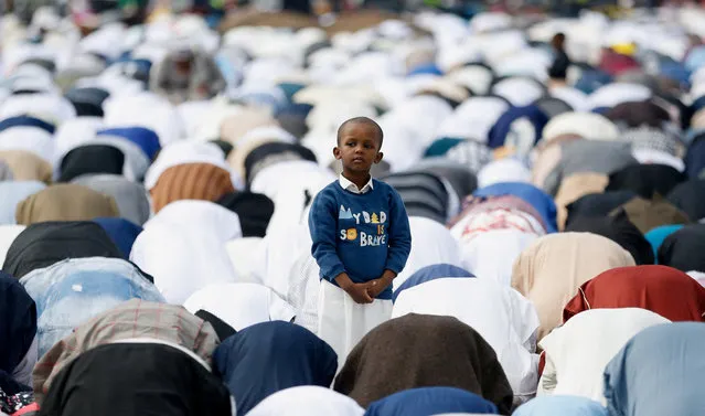A boy stands as Muslim faithful attend Eid al-Fitr prayers, marking the end of the holy fasting month of Ramadan, at the Sir Ali Muslim Club Ground in Ngara district of Nairobi, Kenya on April 10, 2024. (Photo by Thomas Mukoya/Reuters)