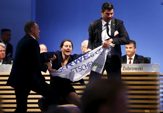 An environment activist is pulled from the stage during the annual shareholders meeting of German power supplier RWE in Essen, Germany April 20, 2016. (Photo by Wolfgang Rattay/Reuters)