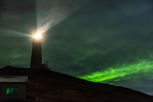 Northern Lights, also called Aurora Borealis, illuminate the night sky over Reykjanes Lighthouse near the town of Grindavik, Iceland on November 19, 2023. (Photo by Marko Djurica/Reuters)