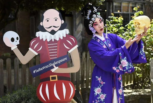 A Chinese performer poses for a friend (out of frame) to take picture outside the house where William Shakespeare was born during celebrations to mark the 400th anniversary of the playwright's death in  Stratford-Upon-Avon, Britain, April 23, 2016. (Photo by Dylan Martinez/Reuters)