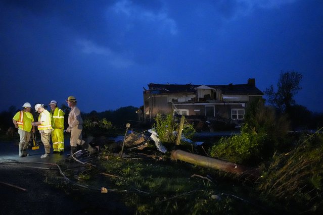 Utility workers survey storm damage along Cothran Road, Wednesday, May 8, 2024, in Columbia, Tenn. (Photo by George Walker IV/AP Photo)