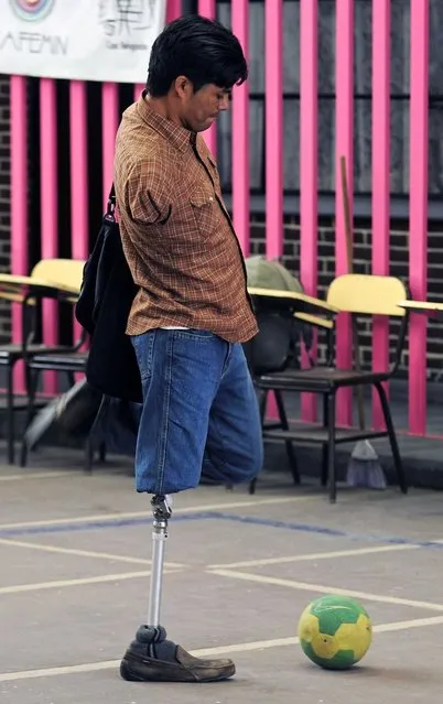 Jose Luis Hernandez, a handicapped Honduran immigrant, plays with a ball in the Nazaret shelter in Mexico City on April 9, 2014. The Mexican government granted humanitarian visas to a group of 15 Honduran immigrants – all victims of accidents whilst traveling in “La Bestia” train heading to the Unitd States – and who are now in Mexico attempting to have an interview with Mexican President Enrique Pena Nieto to tell him about the illegal immigrants problems. (Photo by Alfredo Estrella/AFP Photo)