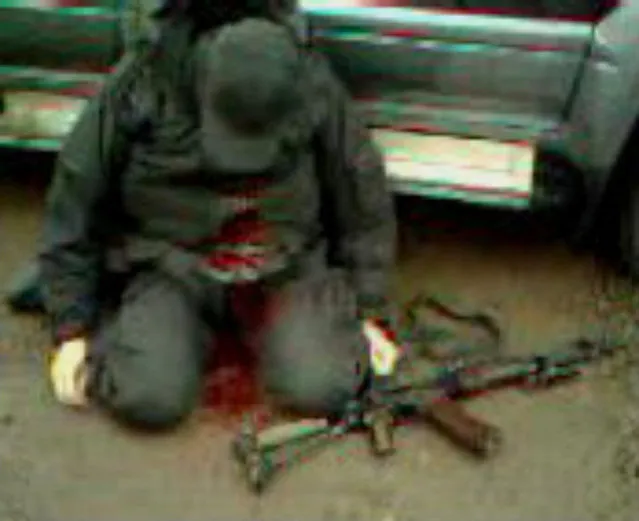 This is an image taken from video of an unidentified gunman killed in a firefight outside the eastern Ukraine town of Slovyansk on Sunday, April 13, 2014. An Associated Press reporter found a bullet-ridden SUV on the side of the road and a pool of blood on the passenger seat where the gunbattle was supposed to have taken place. (Photo by Vladimir Kolodchenko/AP Photo)