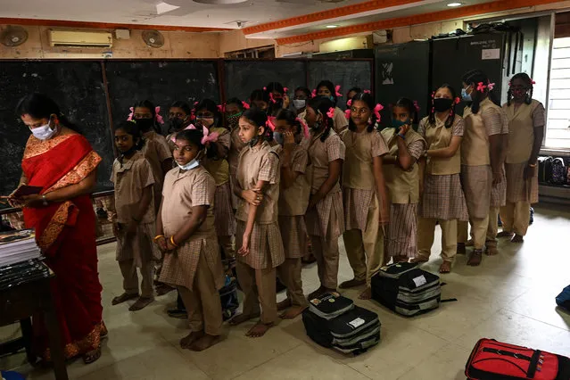 Students assemble to attend classes after the reopening of schools closed as a preventive measure to curb the spread of the Covid-19 coronavirus, at a school in Madurai on February 01, 2022. (Photo by Arun Sankar/AFP Photo)