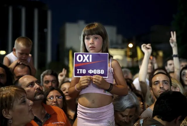 A girl holds up a sign that reads, “No to Fear” in Greek during an anti-austerity demonstration in Syntagma Square in Athens, July 3, 2015. Tens of thousands of Greeks rallied on Monday to back their leftwing government's rejection of a tough international bailout after a clash with foreign lenders pushed Greece close to financial chaos and forced a shutdown of its banking system. (Photo by Yannis Behrakis/Reuters)