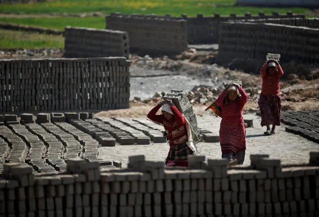 Women carry bricks on their back as they work at a brick factory in Lalitpur, Nepal February 7, 2017. (Photo by Navesh Chitrakar/Reuters)