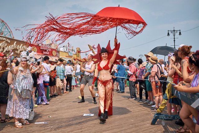 A reveler marches during the Mermaid Parade in the Coney Island section of the Brooklyn borough of New York, on Saturday, June 22, 2024. (Photo by Andres Kudacki/AP Photo)
