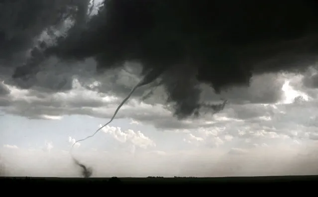 A tornado touches down in a field in Akron, Colo. during a severe weather outbreak on Wednesday, May 7, 2014. The National Weather Service says there have been no reports of injuries or damage after at least two tornadoes touched down briefly on Colorado's Eastern Plains. (Photo by Matt Detrich/AP Photo/The Indianapolis Star)