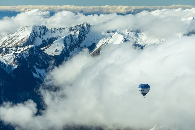 A balloon takes part in the 44th International Hot Air Balloon Festival in Chateau-d'Oex, Switzerland on January 25, 2024. (Photo by Denis Balibouse/Reuters)