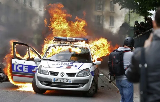 A police car burns during a demonstration against police violence and against French labour law reform in Paris, France, May 18, 2016. (Photo by Charles Platiau/Reuters)