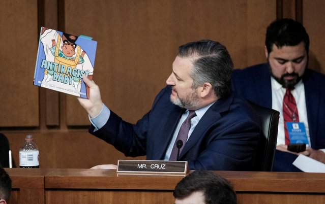 U.S. Senator Ted Cruz (R-TX) holds up the children's book “Antiracist Baby” by Ibram X. Kendi as he questions Judge Ketanji Brown Jackson during her testimony before a Senate Judiciary Committee confirmation hearing on her nomination to the U.S. Supreme Court, on Capitol Hill in Washington, U.S., March 22, 2022. (Photo by Michael A. McCoy/Reuters)