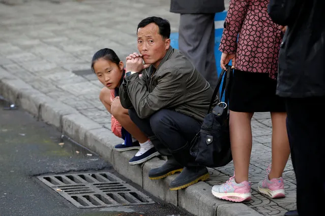 People wait for a bus in central Pyongyang, North Korea on April 17, 2017. (Photo by Damir Sagolj/Reuters)