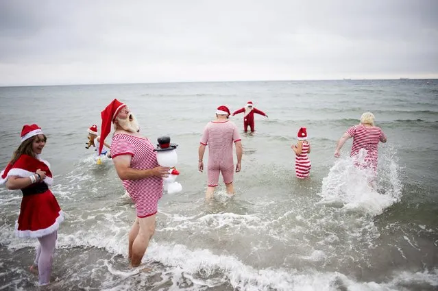 Participants of the World Congress of Santa Clauses 2015 take part in the annual swim at Bellevue beach, north of Copenhagen, Denmark, July 21, 2015. (Photo by Erik Refner/Reuters/Scanpix Denmark)