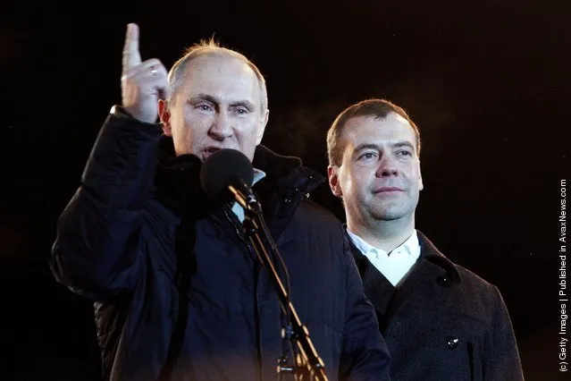 Russian Prime Minister and presidential candidate Vladimir Putin speaks as current President Dmitry Medvedev (R) listens during a rally after Putin claimed victory in the presidential election at the Manezhnya Square March, 4, 2012 in Moscow, Russia