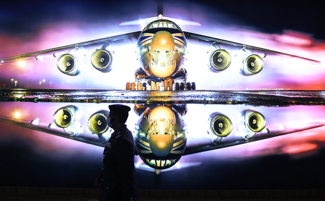 An Emirati walks past the Rostec Pavilion during the exhibition of the Dubai Airshow 2021 at the Dubai World Central – Al Maktoum International Airport, in Jebel Ali, Dubai, United Arab Emirates, 17 November 2021. (Photo by Ali Haider/EPA/EFE)