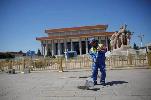 A cleaner sweeps ground in front of the Mausoleum of late Chinese chairman Mao Zedong at Tiananmen Square on the 50th anniversary of the start of the Cultural Revolution in Beijing, China, May 16, 2016. (Photo by Kim Kyung-Hoon/Reuters)