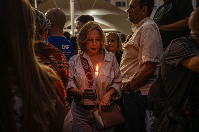 A woman holds a candle during a national vigil for political prisoners called by the opposition, at Los Palos Grandes square, in Caracas,Venezuela, 08 August 2024. According to a report by EFE, Venezuelan President Nicolas Maduro announced during a march on 03 August, that 2000 protesters were arrested. The opposition have been protesting against the official results of Venezuela's 28 July presidential elections and called on the international community to recognize opposition candidate Edmundo Gonzalez as the election winner. The Venezuelan National Electoral Council (CNE) on 02 August 2024 proclaimed Nicolas Maduro as re-elected president of Venezuela. (Photo by Henry Chirinos/EPA/EFE)