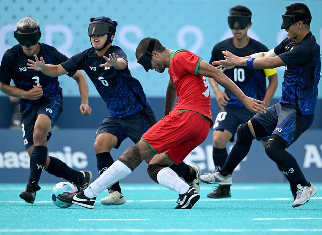 Zouhair Snisla of Team Morocco (second right) is challenged for the ball by Robertoizumi Sasaki (L), Taichi Hirabayashi (second left) and Masaki Goto (R) all of Team Japan during the Blind Football Men's Preliminary Round Group B match between Team Japan and Team Morocco on day five of the Paris 2024 Summer Paralympic Games at Eiffel Tower Stadium on September 02, 2024 in Paris, France. (Photo by David Ramos/Getty Images)