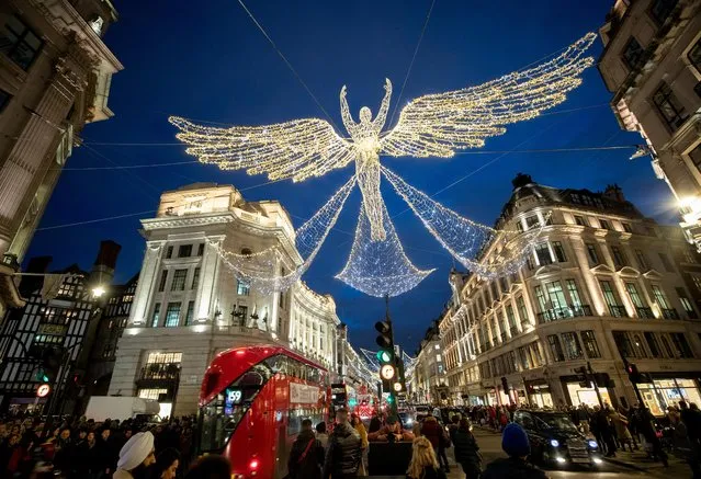 Shoppers make their way as Christmas lights illuminate Regent Street in London, Britain, December 7, 2019. (Photo by Lisi Niesner/Reuters)