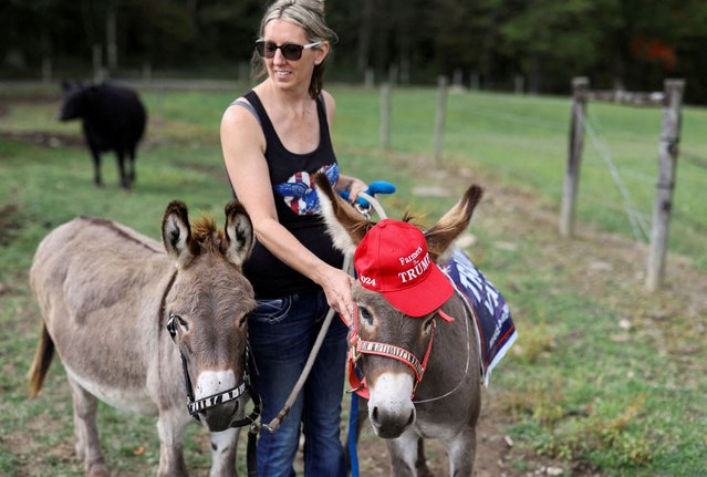 Kristen Glemba stands alongside her donkey Zeke on the day Republican presidential nominee and former U.S. President Donald Trump attends an agricultural policy event in Smithton, Pennsylvania on September 23, 2024. (Photo by Quinn Glabicki/Reuters)