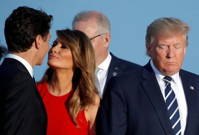 First Lady Melania Trump kisses Canada's Prime Minister Justin Trudeau next to the President Donald Trump during the family photo with invited guests at the G7 summit in Biarritz, France, August 25, 2019. (Photo by Carlos Barria/Reuters)