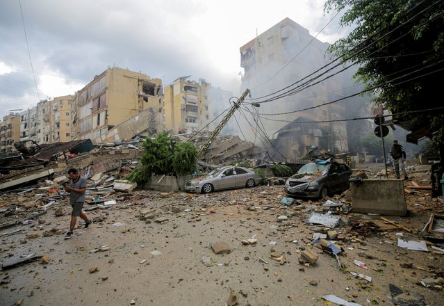 A man walks near damaged buildings, in the aftermath of Israeli strikes on Beirut's southern suburbs, Lebanon on October 1, 2024. (Photo by Ali Alloush/Reuters)