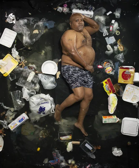 James surrounded by seven days of his own rubbish in Pasadena, California. egal is an unforgettable reminder of the amount of waste a human collects in just seven days. (Photo by Gregg Segal/Barcroft Media)