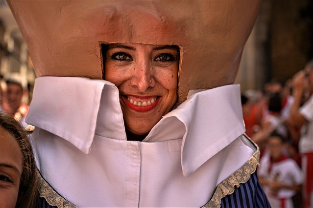 Olga Mutilva, 42, member of San Fermin parade, smiles while taking part in San Fermin fiestas in Pamplona, northern Spain, Friday, July 7, 2023. (Photo by Alvaro Barrientos/AP Photo)