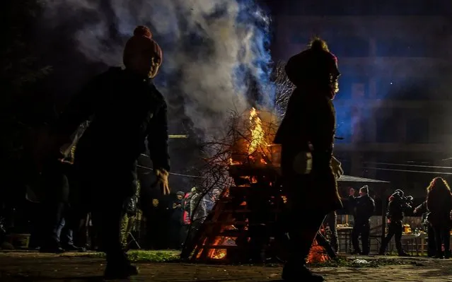 Children run around a bonfire during a traditional gathering in the night before the Christian Orthodox Christmas Eve in Skopje,Republic of North Macedonia, 05 January 2020. Christian Orthodox believers celebrate Christmas according to the Julian calendar on 07 January. (Photo by Georgi Licovski/EPA/EFE/Rex Features/Shutterstock)