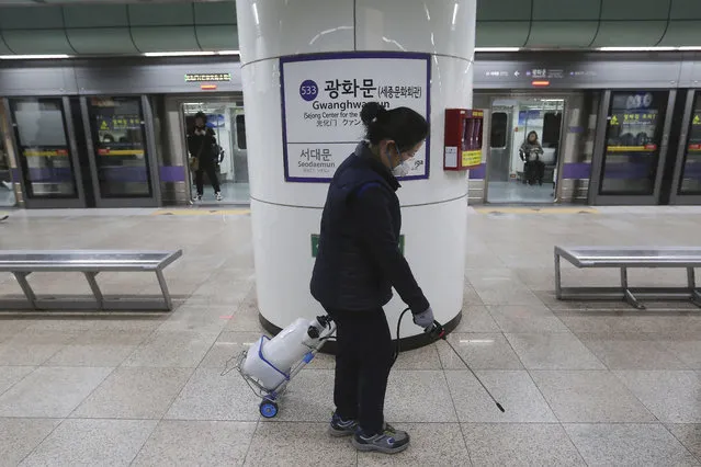 An employee disinfects the platform in hopes to prevent transmission of the coronavirus at a subway station in Seoul, South Korea, Tuesday, January 28, 2020. Deaths from a new viral disease that is causing mounting global concern rose by 25 to at least 106 in China on Tuesday as the United States and other governments prepared to fly their citizens out of the locked-down city at center of the outbreak. (Photo by Ahn Young-joon/AP Photo)