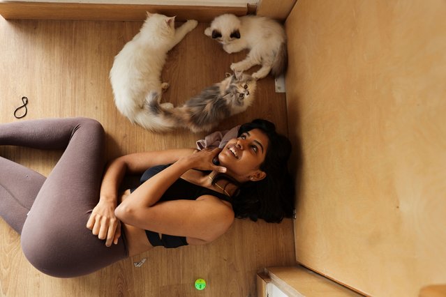 A participant lies next to kittens after the yoga session, which was organised by PawHour, at a studio in New Delhi, India on August 6, 2023. (Photo by Anushree Fadnavis/Reuters)