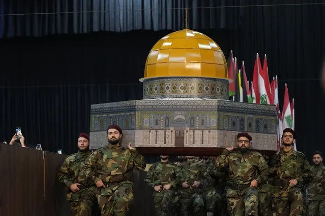 Hezbollah fighters hold a replica of the Dome of the Rock Mosque as march during a rally to mark Jerusalem day or Al-Quds day, in a southern suburb of Beirut, Lebanon, Friday, April 29, 2022. The leader of Lebanon's militant Hezbollah group warned Friday that if Israel continues to target Iran's presence in the region, Tehran could eventually retaliate by striking deep inside Israel. (Photo by Hassan Ammar/AP Photo)
