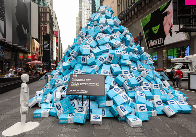 An artwork in Times Square, New York City created from sugar packets and sugar statues, highlights the amount of added sugar consumed by children in the US every five minutes. 45,485 pounds of sugar were put on display along with a sugar statue in the shape of a child on August 22, 2017. (Photo by Broadimage/Rex Features/Shutterstock)