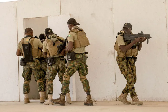 In this Tuesday February 18, 2020, photo, Nigerian Navy Special Boat Service troops exercise under the supervision of British special forces during U.S. military-led annual counterterrorism exercise in Thies, Senegal. More than 1,500 service members from the armies of 34 African and partner training nations have assembled for the Flintlock exercises in Senegal and Mauritania, the two countries in West Africa's sprawling Sahel region that so far have not been hit by violence from extremists linked to al-Qaida or the Islamic State group. (Photo by Cheikh A.T Sy/AP Photo)