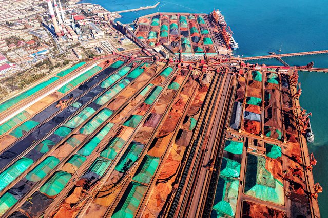 This photo shows an aerial view of imported iron ore piled up at a port in Qingdao, in China's eastern Shandong province on November 29, 2024. (Photo by AFP Photo/China Stringer Network)