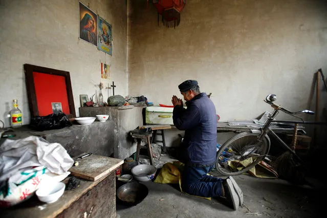 Chinese Catholic Ren Guilong prays at his home in a village on the outskirts of Taiyuan, Shanxi province, December 20, 2007. (Photo by Reinhard Krause/Reuters)