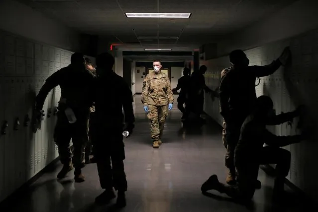 Members of Joint Task Force 2, composed of soldiers and airmen from the New York Army and Air National Guard, work to sanitize the New Rochelle High School during the coronavirus disease (COVID-19) outbreak in New Rochelle, New York, U.S., March 21, 2020. (Photo by Andrew Kelly/Reuters)