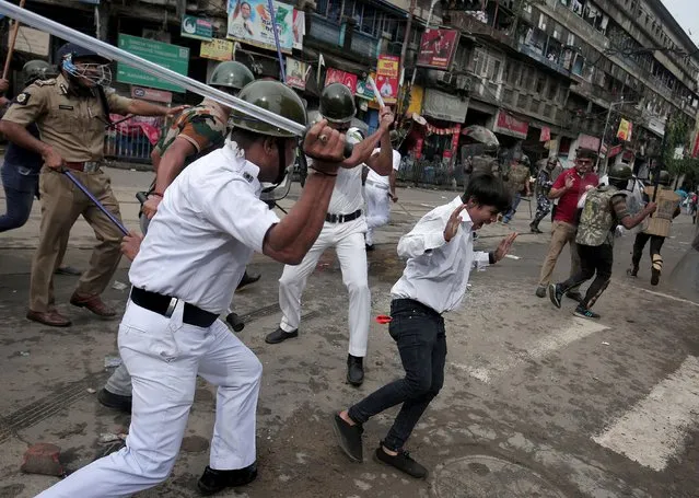 Kolkata police officers apply lathi charge as hundreds of Bharatiya Janata party (BJP) activists march towards Chief Minister Office over education recruitment scam corruption issue in Kolkata, India, 13 September 2022. BJP activists march in a mass rally with a demand for arrest of corrupted leaders of state government. (Photo by Piyal Adhikary/EPA/EFE)