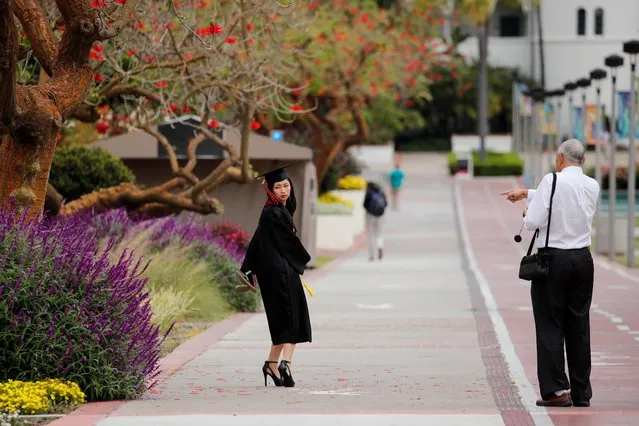 A graduate gets ready to pose for a picture at the empty campus of San Diego State University after the 23 Campuses of California State University system announced the fall 2020 semester will be online, in San Diego, California, May 13, 2020. (Photo by Mike Blake/Reuters)