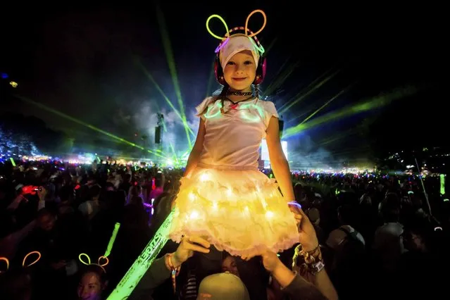 A young girl is lifted up in front of the main stage during the closing show of the 24th Sziget (Island) Festival on Shipyard Island, Northern Budapest, Hungary, 16 August 2016. The festival, which runs from 10 to 17 August, is one of the biggest cultural events of Europe offering art exhibitions, theatrical and circus performances and above all music concerts in eight days. More than 1,500 programs and performers from over 60 countries will entertain the expected 450,000 visitors representing 98 countries of the world. (Photo by Zoltan Balogh/EPA)
