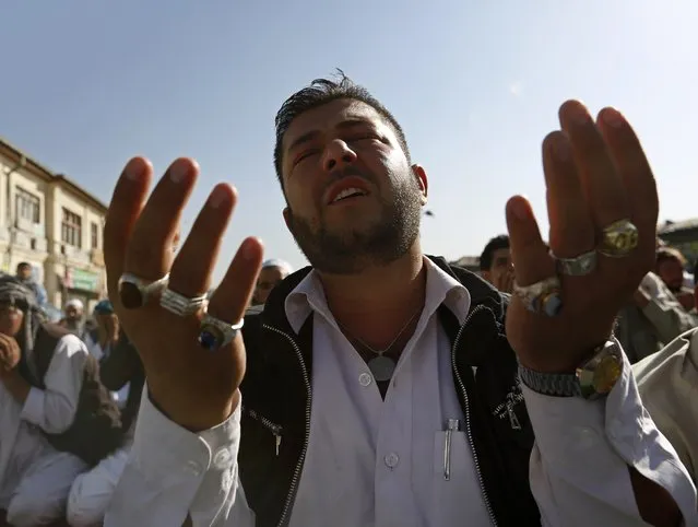 An Afghan man prays after morning prayers on Eid al-Adha in Kabul October 4, 2014. Muslims around the world celebrate Eid al-Adha to mark the end of the haj pilgrimage by slaughtering sheep, goats, camels and cows to commemorate Prophet Abraham's willingness to sacrifice his son, Ismail, on God's command. (Photo by Mohammad Ismail/Reuters)