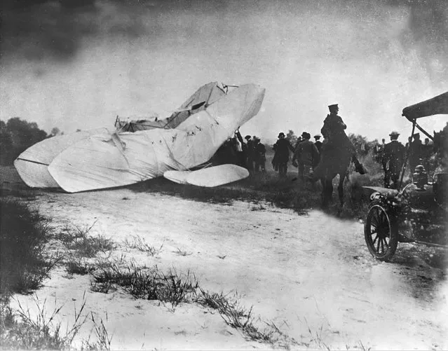 Troops of the U.S. Army Signal Corps rush to the site of a crashed plane to recover the pilot Orville Wright and his passenger, army observer Lieutenant Thomas E. Selfridge, from the wreckage September 17, 1908, in Fort Myer, Va. The plane crashed during a demonstration flight at a military installation; making Lt. Selfridge, who died from his injuries, the first fatality of a military airplane crash. (Photo by AP Photo)