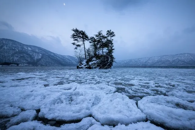 “Frozen lake”. Lake had frozen the morning waning moon is visible. Photo location: Lake Towada Aomori, Japan. (Photo and caption by Sho Shibata/National Geographic Photo Contest)
