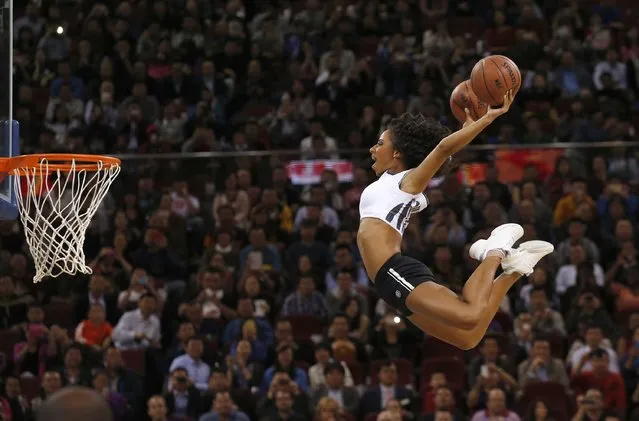 A member of Team Hype jumps to shoot during a performance at the NBA Global Games basketball match between Sacramento Kings and Brooklyn Nets in Beijing October 15, 2014. (Photo by Kim Kyung-Hoon/Reuters)