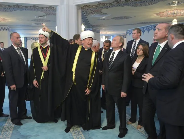 Russian President Vladimir Putin (4th R) and Turkish President Tayyip Erdogan (2nd R) listen to Chairman of the Council of Muftis of Russia Ravil Gainutdin (5th R) during a tour around the Moscow Grand Mosque after an opening ceremony in Moscow, Russia, September 23, 2015. (Photo by Alexei Druzhinin/Reuters/RIA Novosti/Kremlin)