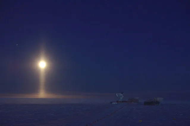 Winner, Astronomy category. Lunar Spotlight, South Pole, Antarctica, by Daniel Michalik. Ice crystals suspended in the atmosphere create a rare optical phenomenon: a light pillar underneath the Moon. (Photo by Daniel Michalik/PA Wire/Royal Society Publishing Photography Competition 2017)
